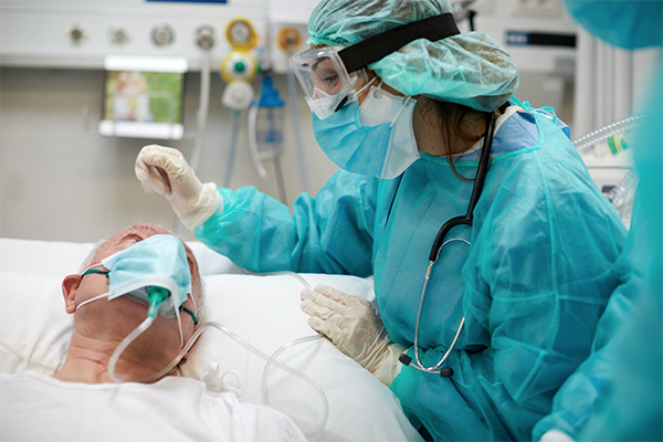 A nurse checks bedside on a patient
